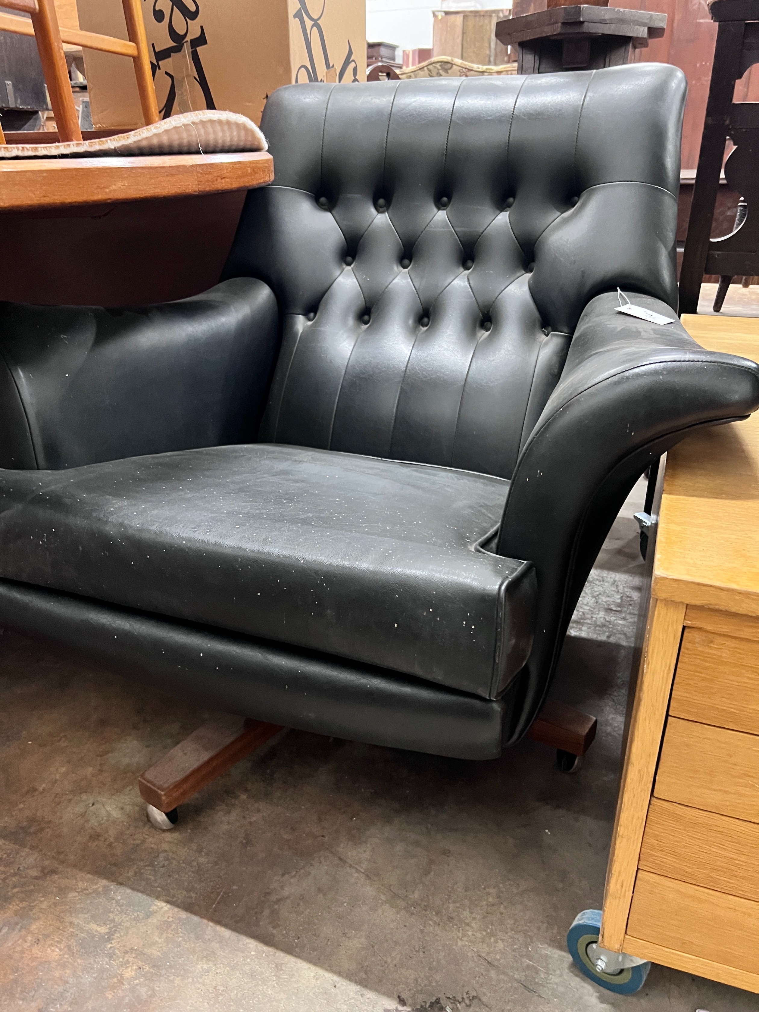 A G Plan black leatherette upholstered revolving armchair, width 93cm, depth 82cm, height 82cm *Please note the sale commences at 9am.